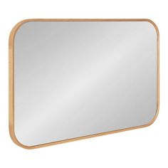 a wooden frame mirror on a white wall with a light brown border around the edge