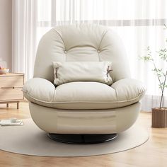 a white chair sitting on top of a hard wood floor next to a vase filled with flowers