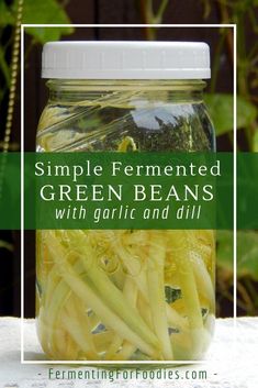 fermented green beans in a mason jar on a table with text overlay