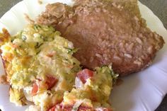 an omelet and hash browns on a paper plate