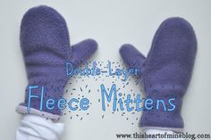 two purple mittens sitting next to each other with the words double layer fleece mittens