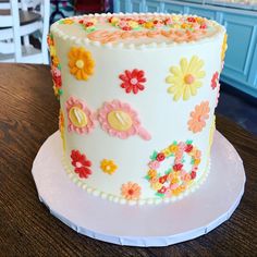 a decorated cake sitting on top of a wooden table