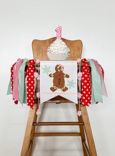 a wooden chair with a cupcake banner on it