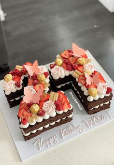 there is a chocolate cake with strawberries and flowers on it