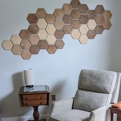 a living room with a chair, table and wall art