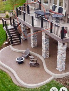 an outdoor patio with stone pillars and chairs