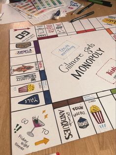 a close up of a monopoly board game on a table with markers and pencils