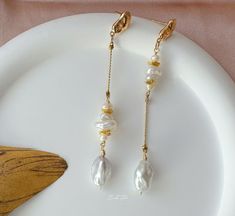 These earrings feature genuine freshwater baroque pearls delicately connected with small, varied shapes of Keshi pearls, creating an enchanting asymmetrical design and graceful lines.  P E A R L ∙ E A R R I N G S ✨Total Length : about 8.5 cm ✨Color: natural untreated, metallic white with tint of blue overtone ✨Material: Ear studs are gold plated S925 sterling silver, suitable for sensitive skin.  It is nickel free, hypoallergenic, tarnish resistant O T H E R ∙ I N F O R M A T I O N ✨ Our pieces are made with care and attention to details. ✨Freshwater pearls are entirely natural, which means that each one has its own distinct size and shape. I'll take care to ensure that the pearls harmonize beautifully with each other. ✨ The orders typically take 1-3 days to process.  ✨ Your satisfaction i Delicate Baroque Pearl White Earrings, Baroque Pearl Drop Earrings For Jewelry Making, Delicate Baroque Pearl Earrings With Pearl Charm, Delicate Baroque Pearl Earrings For Pierced Ears, Minimalist Baroque Pearl Earrings With Pearl Chain, Minimalist Baroque Pearl Earrings In Pearl White, Handmade Delicate Baroque Pearl Earrings, Delicate Baroque Pearl Drop Earrings, Dainty Baroque Pearl Drop Earrings