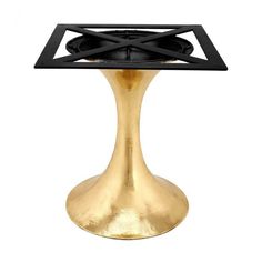 a gold and black table with an iron base