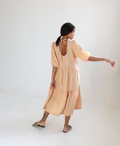 "Dreamy and romantic linen dress with layered gathered areas and subtle tie-detail over an open back. Offered in light-weight linen. STYLE DETAILS * 4 sizes, easily adjustable * Relaxed fit * Trapeze silhouette * Open back with ties * Elasticated puffy 3/4 sleeves * Two inside pockets * Mid-calf length * French seams inside * Light weight linen SIZES & COLORS IN THE PICTURES * Models are wearing size M in Sheepskin (light) linen. * Model 1's height - 175 cm (5'9\"), bust - 80 cm (31.5\"), wa Linen Tiered Dress For Daywear, Maternity Summer Dress With Puff Sleeves, Summer Maternity Dress With Puff Sleeves, Linen Puff Sleeve Dress With Ruffles, Linen Slip Dress, Baby Shower Dress, Bridesmaid Dresses Boho, Regency Dress, Beach Mini Dress