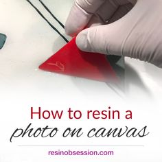 a person in white gloves is using a red triangle to make a photo on canvas