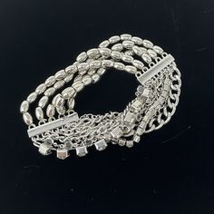 "🌼 Multi strand Silver tone stretch bracelet with chain, beads and rhinestones by Chicos. 🌼 Measures: 1 1/4\" wide.  The beads are stretchy so will fit most wrists. 🌼 Condition: very good, minimal wear. Please see all photos for complete details. For more vintage jewelry in my shop, please visit: https://www.etsy.com/shop/TheVintageDaisyVault?ref=seller-platform-mcnav&section_id=25440304" Multi-strand Metal Bracelets For Party, Silver Multi-strand Party Bracelets, Adjustable Ball Chain Jewelry For Party, Metal Beaded Bracelets With Bling For Party, Silver Multi-strand Chain Bracelet, Crystal Beaded Bracelets With Silver Beads For Party, Silver Stretch Bracelet With Rhinestones, Silver Rhinestone Bracelet In Costume Jewelry Style, Party Crystal Beaded Bracelets With Silver Beads