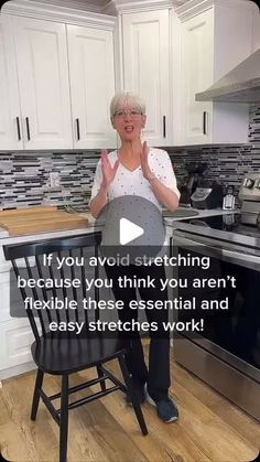 an older woman standing in front of a kitchen counter with her hands up to the camera