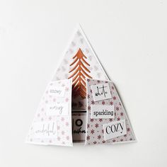 an origami christmas tree with greetings inside