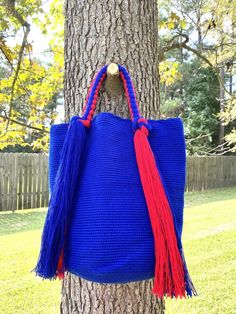 These beautiful, one-of-a-kind, 100% handmade top handle bag has been carefully crocheted by women from the Wayuu tribe in La Guajira, Colombia.This beautiful Wayuu braided bag is carefully crafted using a double thread technique for the body. Approximate dimensions:Height: 11-12 inchesWidth: 13 inchesDepth: 4 inchesEach piece represents approximately 1 week of work for a single artisan.**Listing is for 1 Wayuu bag only.**Please choose color in the drop down options. Blue Square Handwoven Shoulder Bag, Blue Crochet Bag With Top Handle For Everyday Use, Blue Handwoven Top Handle Bag, Handmade Top Handle Bucket Bag For Travel, Handmade Blue Bucket Bag For Everyday Use, Handmade Top Handle Bucket Bag For Everyday Use, Handmade Blue Shoulder Bucket Bag, Blue Crochet Bag With Handles For Everyday Use, Handmade Rectangular Satchel For Shopping