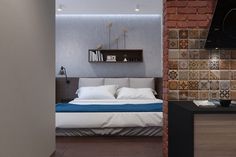 a bed sitting next to a brick wall in a bedroom