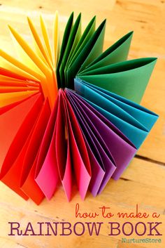 an origami rainbow book with text overlay reading how to make a rainbow book