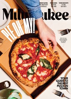 a magazine cover with a person grabbing a slice of pizza from a box on the table