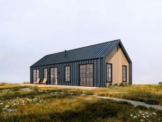 a small house in the middle of a grassy field