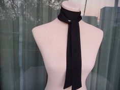 This skinny black scarf is made by 100% silk satin, and creates a beautiful and lovely picture for you to wear with your favorite outfit.  It has the perfect length to wear in different ways like as a bow, a skinny scarf or tie around your neck or on your head. It can be use as a headband and choker necklace also. So many ways to wear it!   Size: 3,5cm x 1,38 cm (28 euro) 5 cm x 138 cm (35 euro) 3,5 cm x 1,80 cm (35 euro) 5 cm x 1,80 cm (42 euro) 7 cm x 1,80 cm (49 euro) Wash gently in cold water. It's a wonderful gift choice for everyone. Check also my other silk scarves: https://www.etsy.com/shop/ArtTetisCollections Ready to ship. Thank you for visiting my shop. Chic Black Silk Scarf Gift, Elegant Adjustable Neckwear For Gifts, Silk Scarf With Ribbon For Gift, Elegant Adjustable Neckwear As Gift, Elegant Adjustable Neckwear As A Gift, Formal Scarf Neckwear, Elegant Scarves With Ribbon For Gift, Elegant Solid Color Adjustable Neckwear, Elegant Adjustable Neckwear