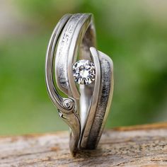 a close up of a ring on top of a wooden table with the words johan jewelry