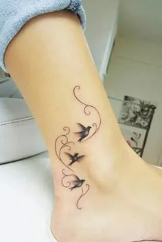 a woman's foot with two birds on it