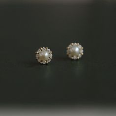 Simple and timeless. Every girl needs a pair of classic pearl studs in their jewelry box! This pair has a modern twist, with a 14K gold or silver halo of alternating CZ stones and shiny beads surrounding a gorgeous faux pearl. DETAILS & SIZE Sold as a pair Finish: 14K gold plate Materials: .925 sterling silver; CZ stones; faux pearl Measurements: 7mm Comes with friction earring backs Shop the Ear Bar to curate your ear stack Pearl Earrings Studs With Diamonds, Daily Wear Pearl Gold Earrings, Pearl Small Earing, Ear Studs Indian Gold, Traditional Gold Pearl Earrings, Gold Earrings Designs Simple, Pearl Studs Earrings Gold, Ear Studs Indian, Pearl Studs Earrings Gold Indian