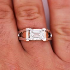 2.87 carat, Emerald cut, G-H color, VVS2-VS1 clarity lab-grown diamond set in 2-tone rose/pink and white 14k gold. This ring is for men in search of a chic and classy statement piece that no one else has. A ring that communicates the message of refined and sophisticated taste in fine jewelry. The shank is expertly engineered with sharp edges that play perfectly to the sharp step-cuts of the emerald-cut center stone. Comes with free FedEx overnight shipping, Certificate of Appraisal, ring box + t Luxury Elegant Men's Emerald Cut Ring, Luxury Classic Men's Emerald Cut Ring, Luxury Gold Men's Ring With Emerald Cut, Timeless Luxury Men's Ring With Baguette Cut, Luxury Men's Emerald Ring With Prong Setting, Exquisite Diamond White Emerald-cut Diamond Ring, Rosé Pink, Diamond Mens Ring, Cut Rings