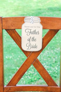 a wooden chair with a sign on it that says, property for the father of the bride