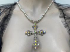 Large filigree cross pendant pearl chain. Cross has iridescent rhinestone. I have used two colour pears for the chain. Light cream rose 10 mm glass pearls and ivory 6 mm glass pearls. Cross is zinc alloy. I can do any colour pearls to suit you. White Cross Necklace For Party, Silver Cross Necklace With Pearl Drop, Silver Cross Jewelry With Pearl Chain, Pearl Drop Cross Pendant Necklace, Beaded Cross Necklace For Wedding, White Cross Necklace With Rhinestones, Baroque Cross Necklace, Elegant Cross-shaped Pearl Pendant Necklace, Cross-shaped Pearl Pendant Necklace