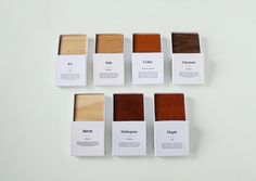 six different types of wood are shown in the box on the white surface, including one for each color