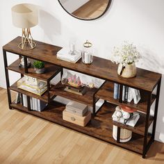 a wooden shelf with books and vases on it