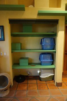 the shelves are filled with plastic containers and litter cans in this small room that is also used for storage