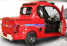 a red truck with its door open on the street