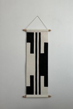 a black and white wall hanging on the wall