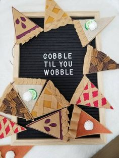 there is a sign that says gobble til you wobble with some paper decorations on it