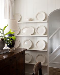 a room with white plates on the wall