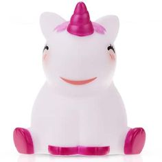 a small white toy with a pink horn on it's head and legs sitting down