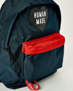 The Human Made Backpack delivers a sleek, lightweight design with a standout PVC heart logo and practical functionality. Featuring a spacious main zip compartment, an inner pocket, and adjustable padded shoulder straps, this bag combines street-ready style with everyday utility. PVC heart logo on the front. Patch label on the back. Interior woven patch label. Main zip compartment with inner pocket. Front compartment with a branded webbing loop under. Adjustable padded shoulder straps. 100% Nylon Functional Backpack With Logo For Everyday Use, Everyday Backpack With Logo, Everyday Logo Backpack, Nylon Backpack With Logo For Everyday Use, Everyday Nylon Backpack With Logo, Everyday Nylon Bag With Logo, Functional Everyday Backpack With Logo Patch, Nylon Logo Backpack, Nylon Standard Backpack With Logo Patch