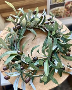 an olive wreath sitting on top of a wooden table