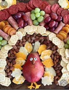 a turkey made out of crackers, grapes and nuts