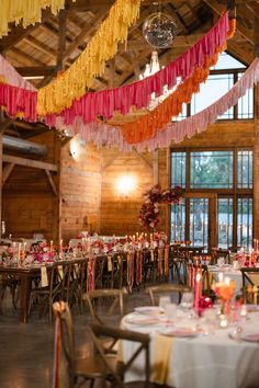 the tables are decorated with colorful streamers and candles for an elegant wedding or special event