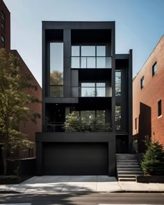 a black building with lots of windows on the top floor and stairs leading up to it