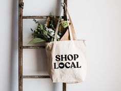 "Shop Local"Designed with love and printed by hand, this heavy canvas tote bag is the perfect eco-conscious companion for your local market trips! Eco-friendly Tote Canvas Bag For Shopping, Organic Style Tote Bag For Shopping, Organic Tote Bag For Shopping, Eco-friendly Canvas Bag For Market, Eco-friendly Canvas Bag, Eco-friendly Cotton Canvas Market Bag, Cotton Tote Canvas Bag For Market, Cotton Canvas Tote Bag For Market, Eco-friendly Canvas Shopping Bag