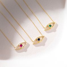 Birthstone Evil Eye Necklace! This beautiful necklace features a gold evil eye charm on a delicate gold chain. The perfect gift for mothers, girlfriends, and wives, this necklace is perfect for everyday wear. The perfect gift for any occasion, this necklace is sure to please. The high quality 925 sterling silver, 14k gold plating, 14k rose gold plating, 14k solid gold, and 18k solid gold make this necklace a stunning and unique piece of jewelry. Get yours today! Features * Made to Order * Materi Gold Plated Birthstone Necklace For May, Yellow Gold Birthstone Necklace With Delicate Chain As Gift, 14k Gold Evil Eye Charm Necklace As Gift, Spiritual Yellow Gold Birthstone Necklace Gift, Elegant Evil Eye Necklace For Gift, Gold Minimalist Birthstone Necklace As Gift, Elegant Evil Eye Necklace Gift, Minimalist Gold Birthstone Necklace For Gift, Minimalist Gold Birthstone Necklace Gift