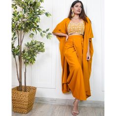 Made with absolute perfection, this 3 piece indo-western ethnic wear is perfect for wedding/party wear. It has an embroidered work crop top with a dhoti skirt and a long jacket. The fabric used is Viscose Sizes: S (bust-32inches, waist-29inches), M (bust-34inches, waist-31inches), L(bust-35.5inches, waist-33inches) Pattern: Embroidered Style: Indo-Western Dress For Women, Crop Top With Dhoti Skirt And Long Jacket Shrug Set, Indian Dress, Wedding Guest Outfit Occasion: Festive Wash Care: Hand Was Eid Lehenga Semi-stitched Front Open, Eid Front Open Semi-stitched Lehenga, Traditional Drape Chinon Sets For Navratri, Unstitched Maxi Length Sets For Diwali, Festive Designer Sets With Front Open Design, Festive Designer Sets With Front Open, Festive Front Open Designer Sets, Bollywood Style Front Open Lehenga For Eid, Eid Front Open Sets With Resham Embroidery