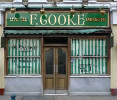 a store front with green and white striped awnings