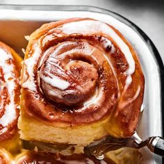 cinnamon rolls with icing in a baking dish