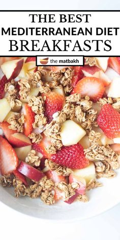 a bowl filled with granola and strawberries on top of a white tablecloth