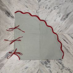 a red and white place mat on top of a marble floor with lines drawn across it